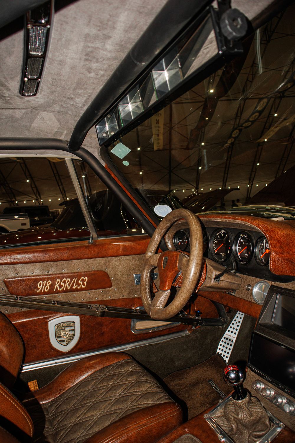 Classic Porsche interior featuring wooden dashboard and vintage steering wheel.