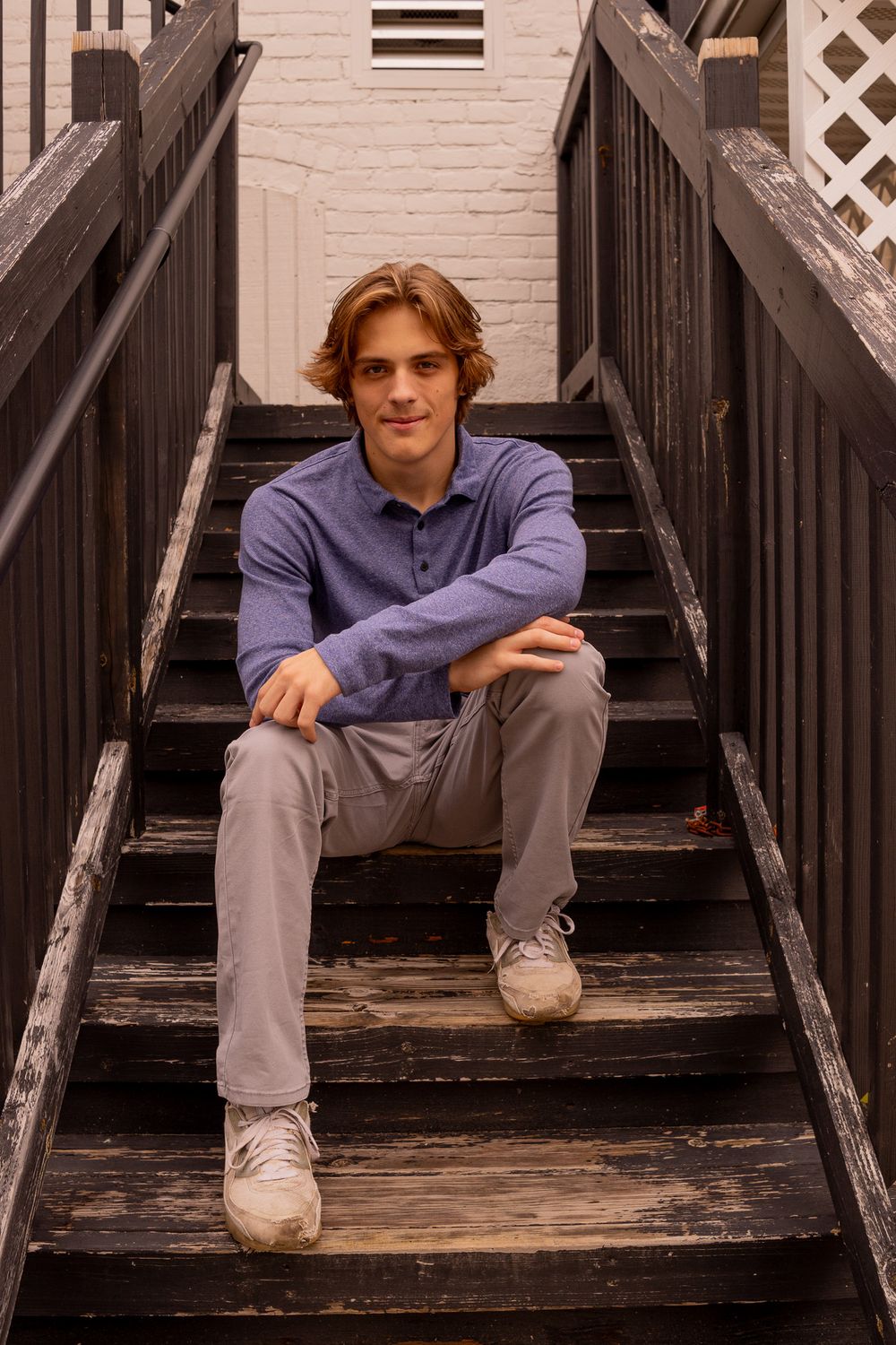 teenage boy seating on steps for senior pictures