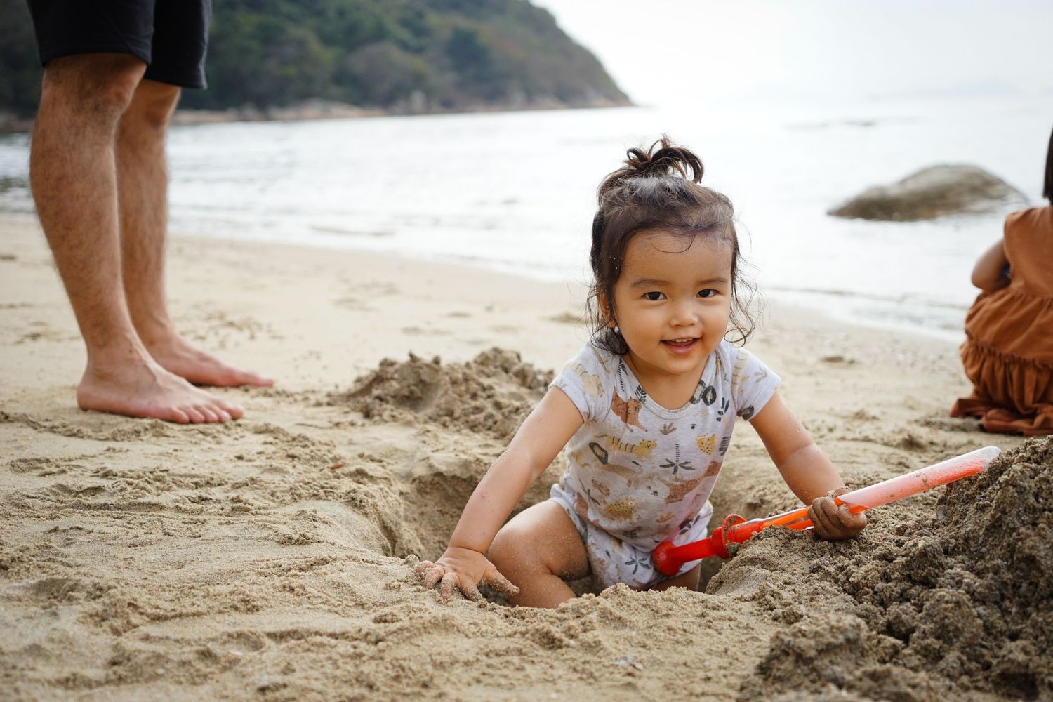 Toddler playing in the sand on the beach