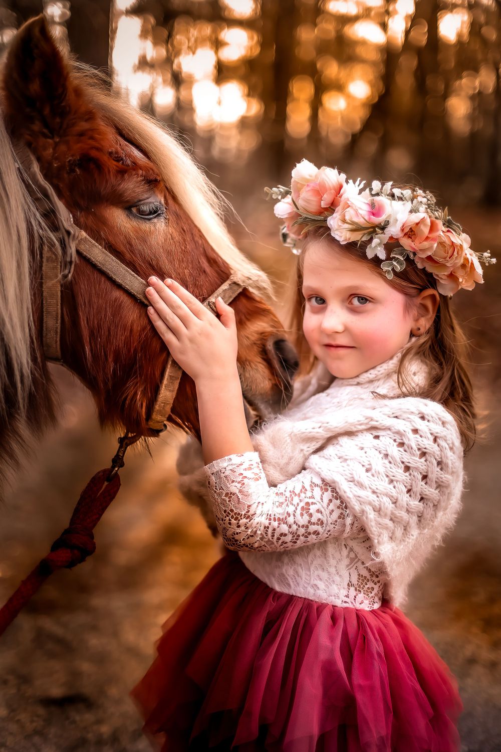 Enchanting portrait with horse and flower crown in dreamy forest setting.