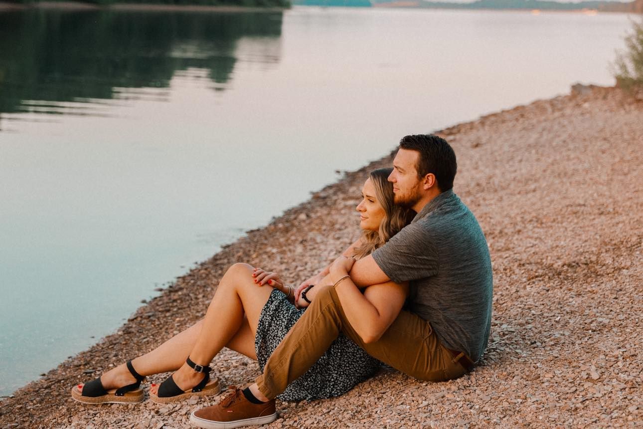 Couple sitting by lake
