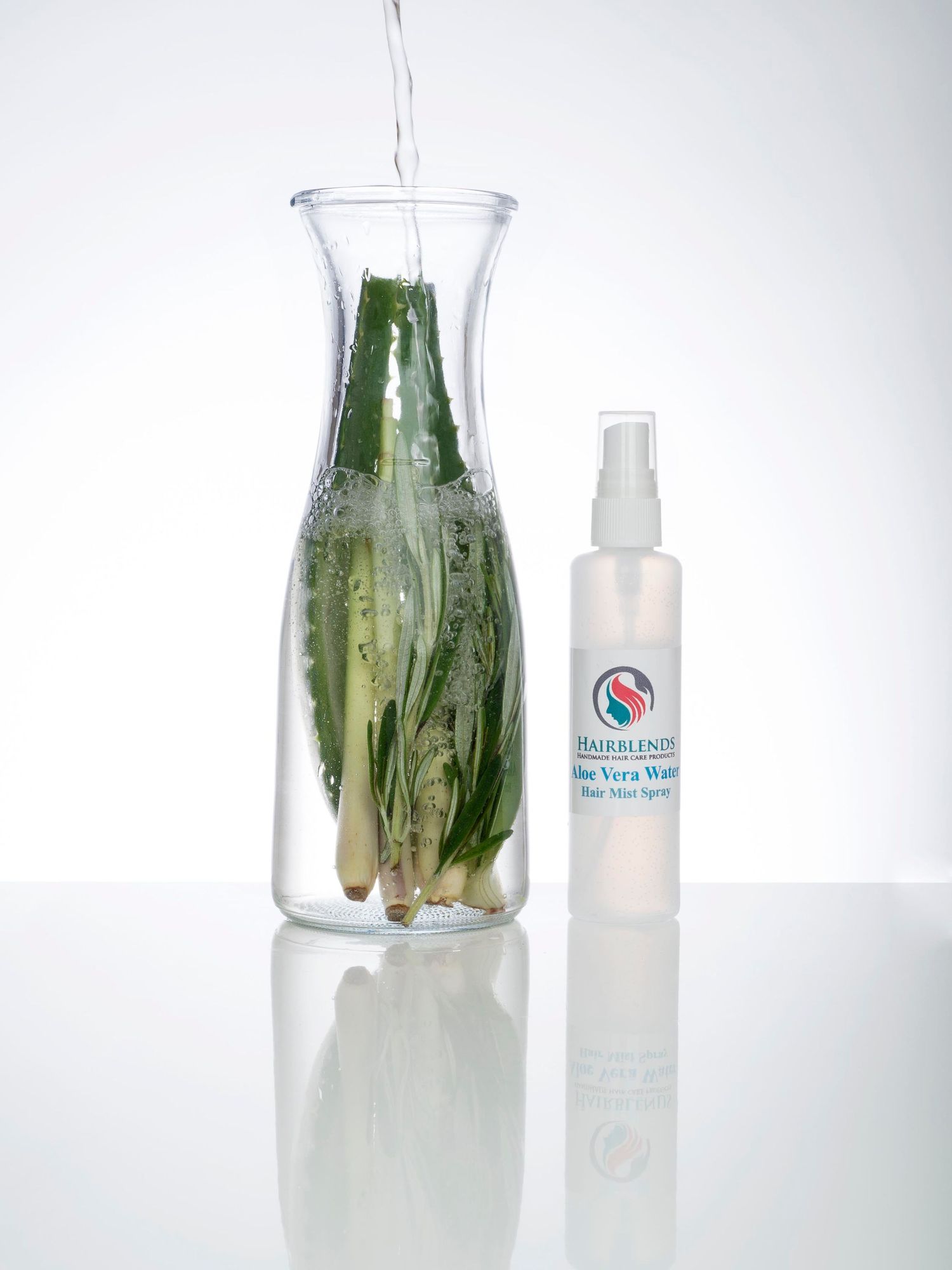 A glass vase next to a bottle of water, illustrating creative product photography for aloe vera hair mist by Abigail's Studio.