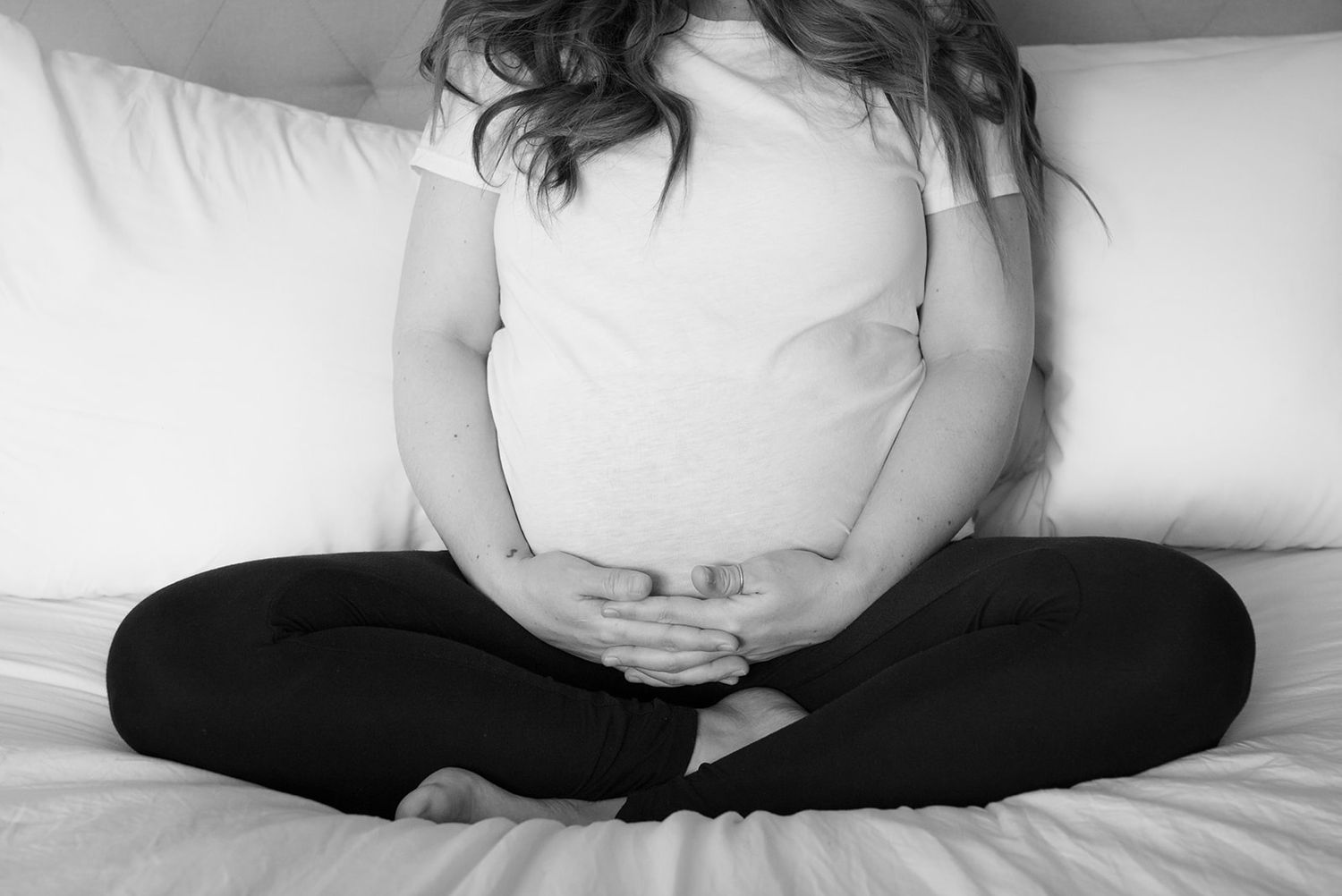 Mother cradling her pregnant belly during her maternity session in Erie, Colorado