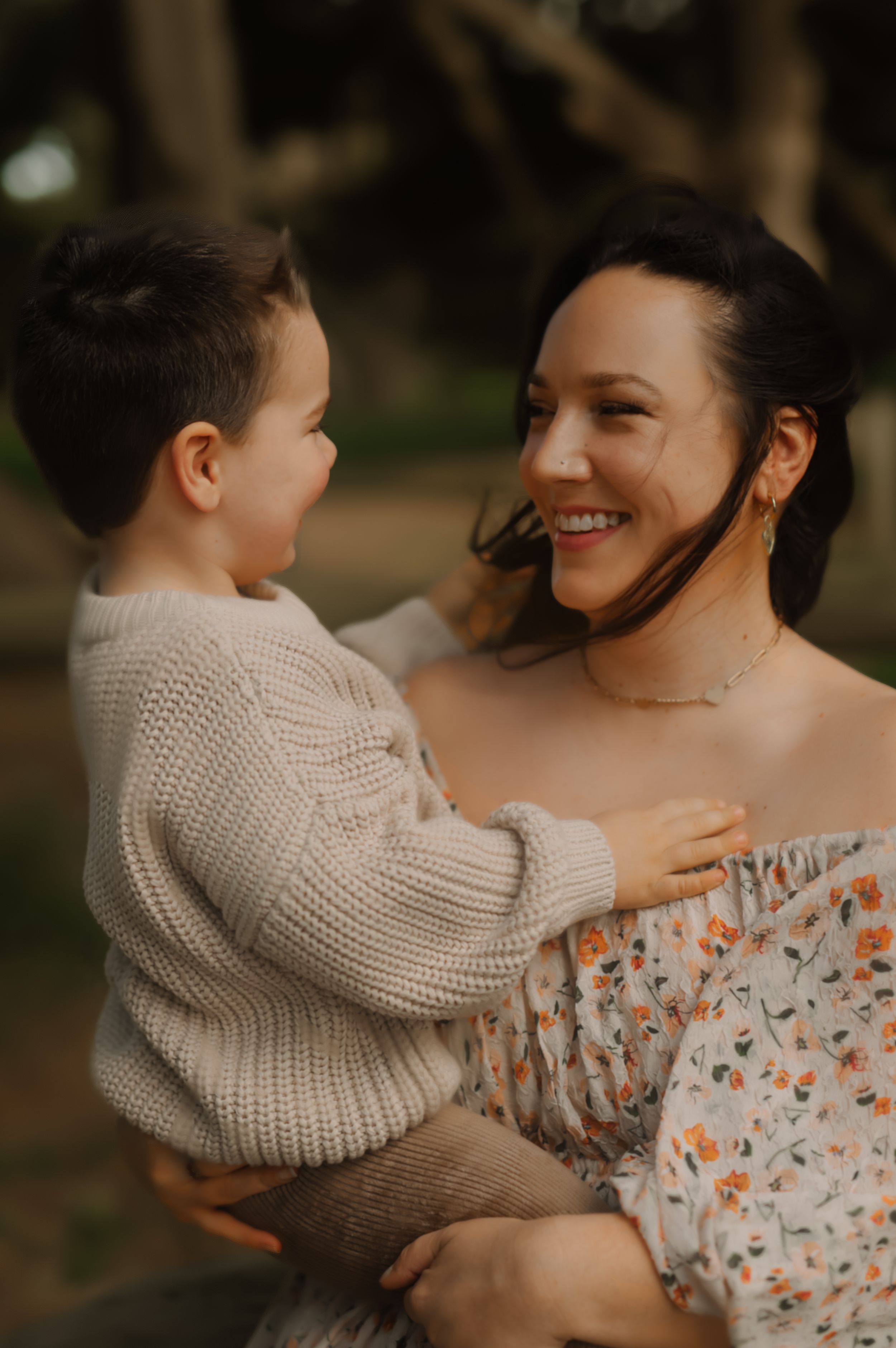 A tender family moment captured in warm tones as a child in a knit sweater embraces lovingly.