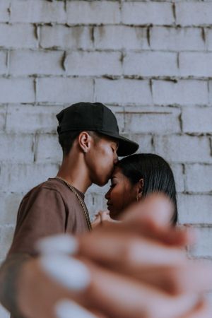 Close-up romantic photography sequence showing couple in matching brown outfits.