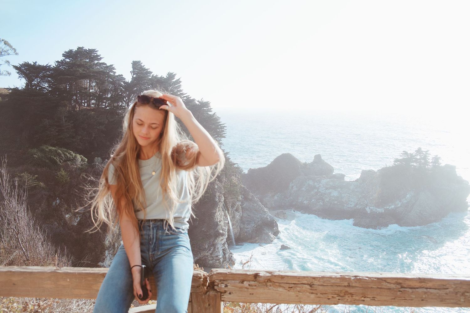 Scenic coastal photography with rocky cliffs and ocean waves in background.