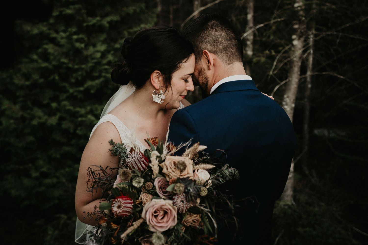 bride and groom close together with bridal bouquet