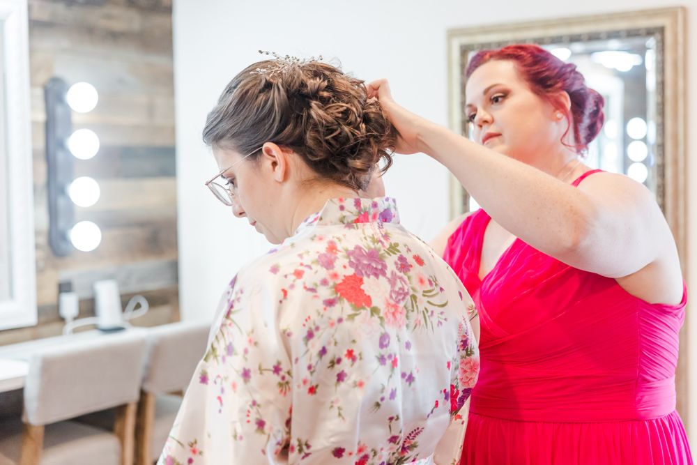 Final wedding preparations being made in a dressing room with mirrors and lights.