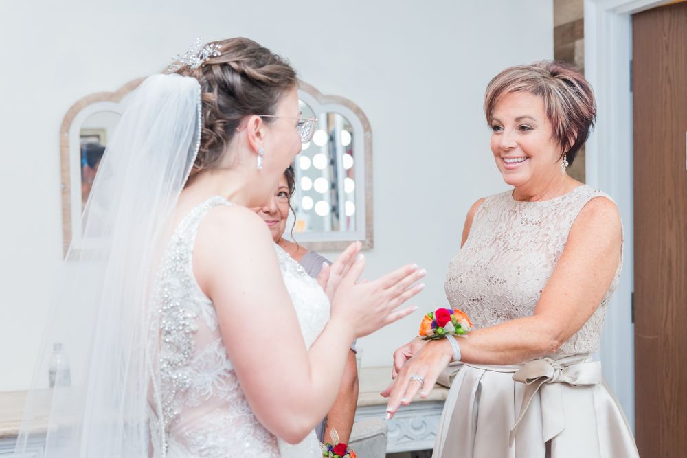 Emotional moment shared during wedding preparation in a bridal suite.