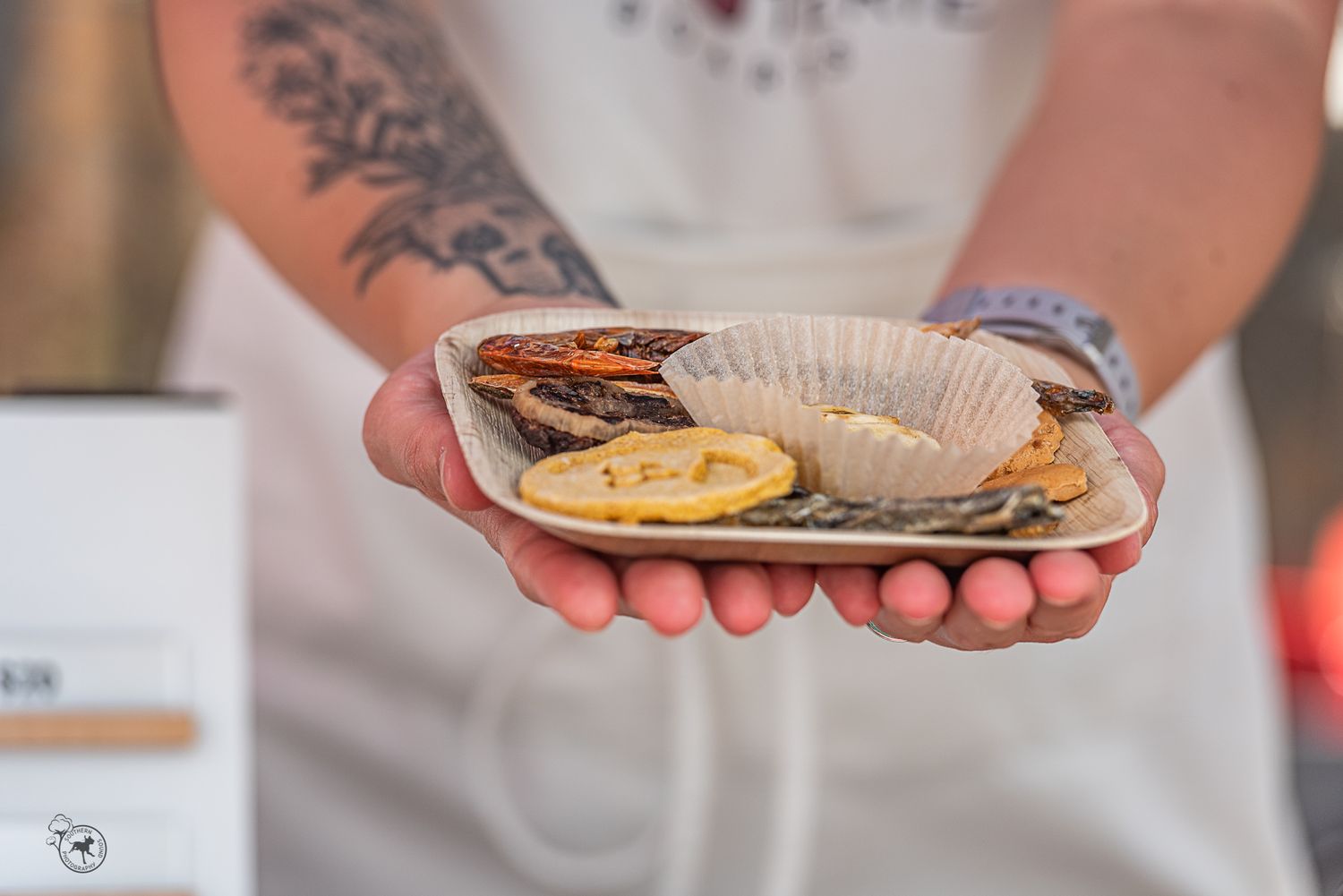 Female entrepreneur holds charcuterie board made for dogs in Chapin, South Carolina. Image curated for branding.
