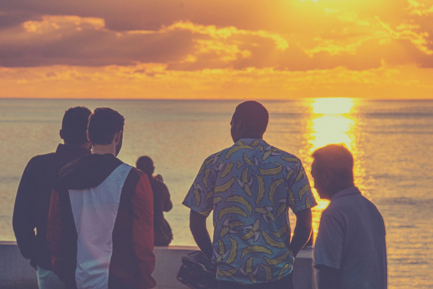 Photo of men at sunset