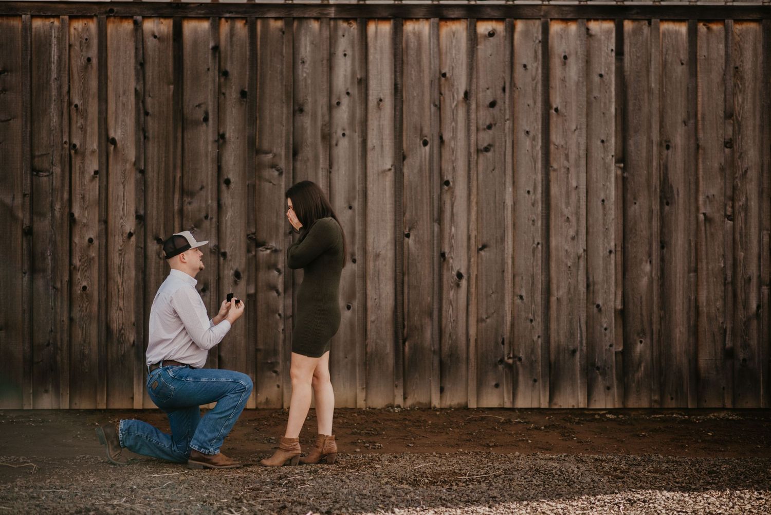 Proposal moment captured against rustic wooden wall background.