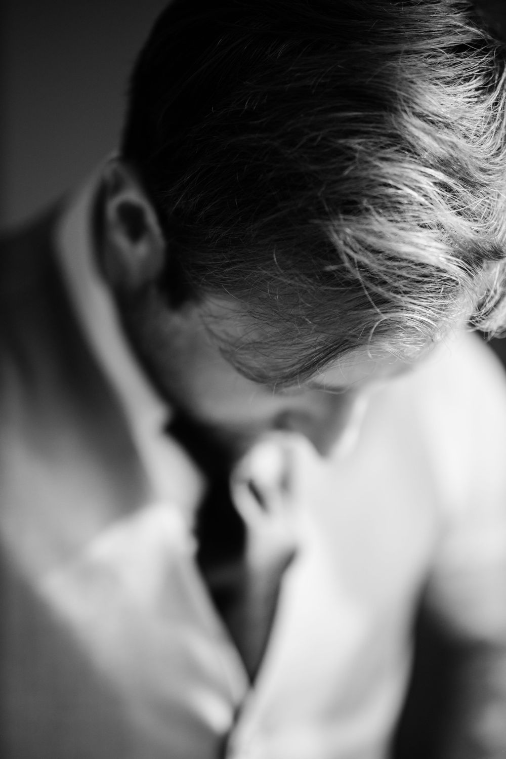 Black and white close-up portrait with dramatic lighting and shallow depth of field.