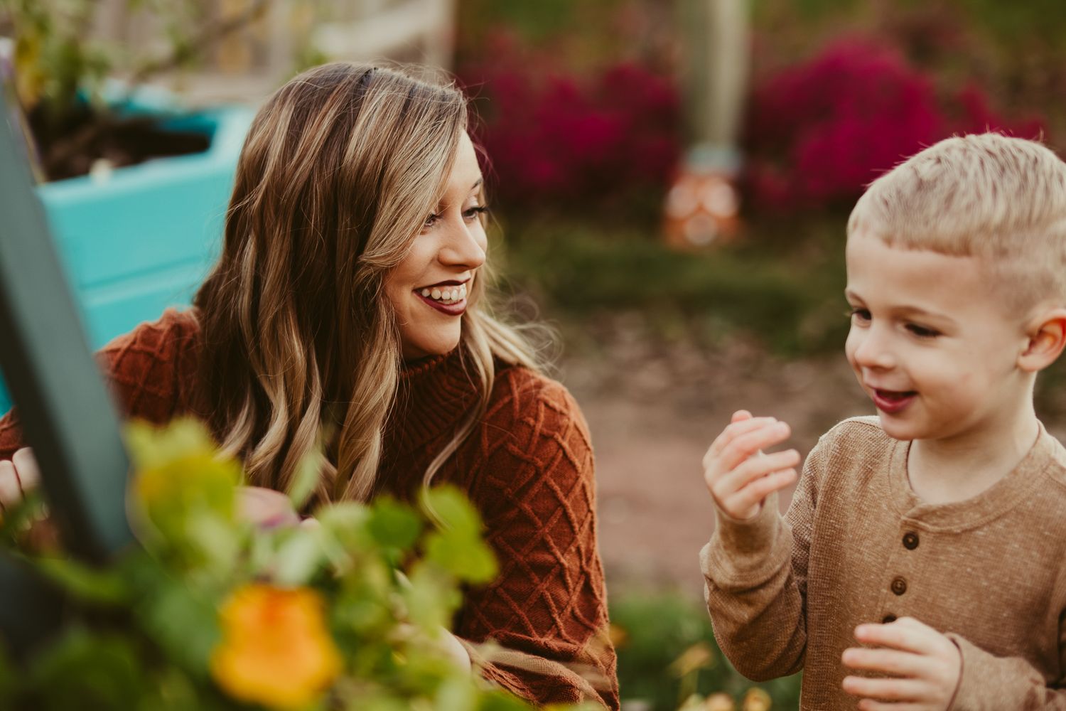Genuine laughter shared while exploring blooming garden together.