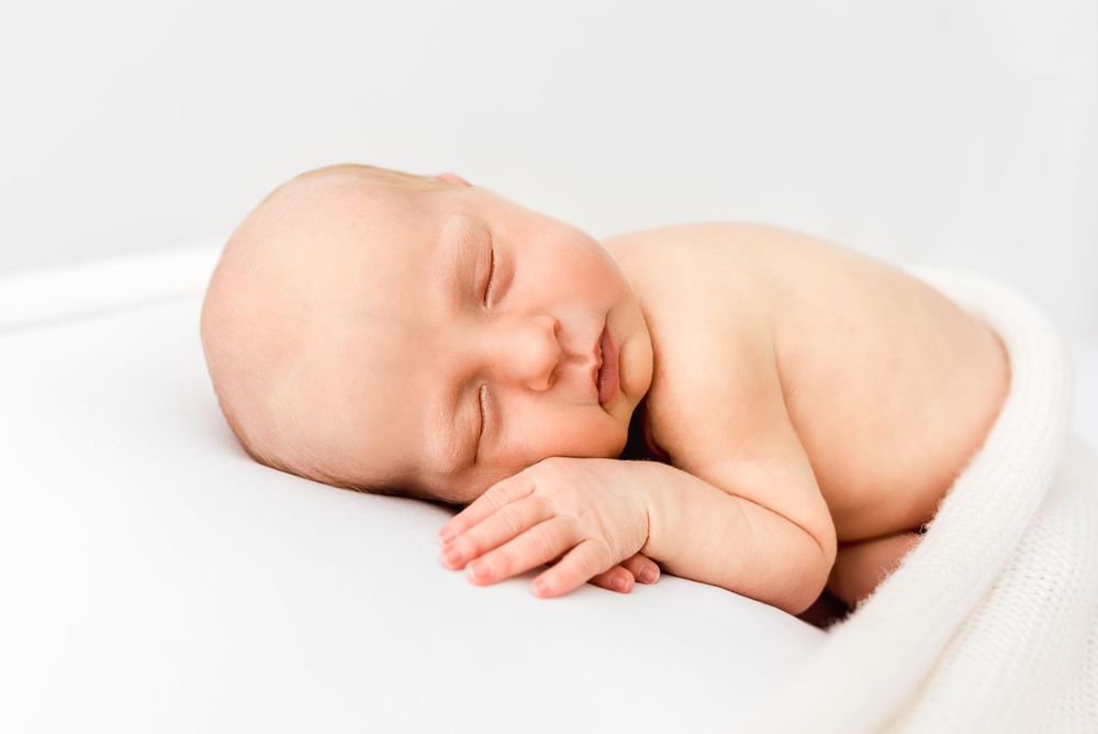 Natural newborn photography in home all-white studio Hereford