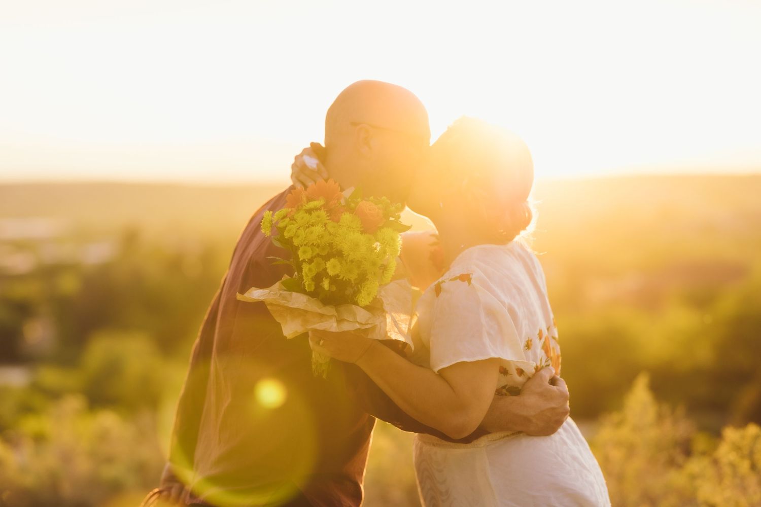 Bride and Groom kissing at sunset