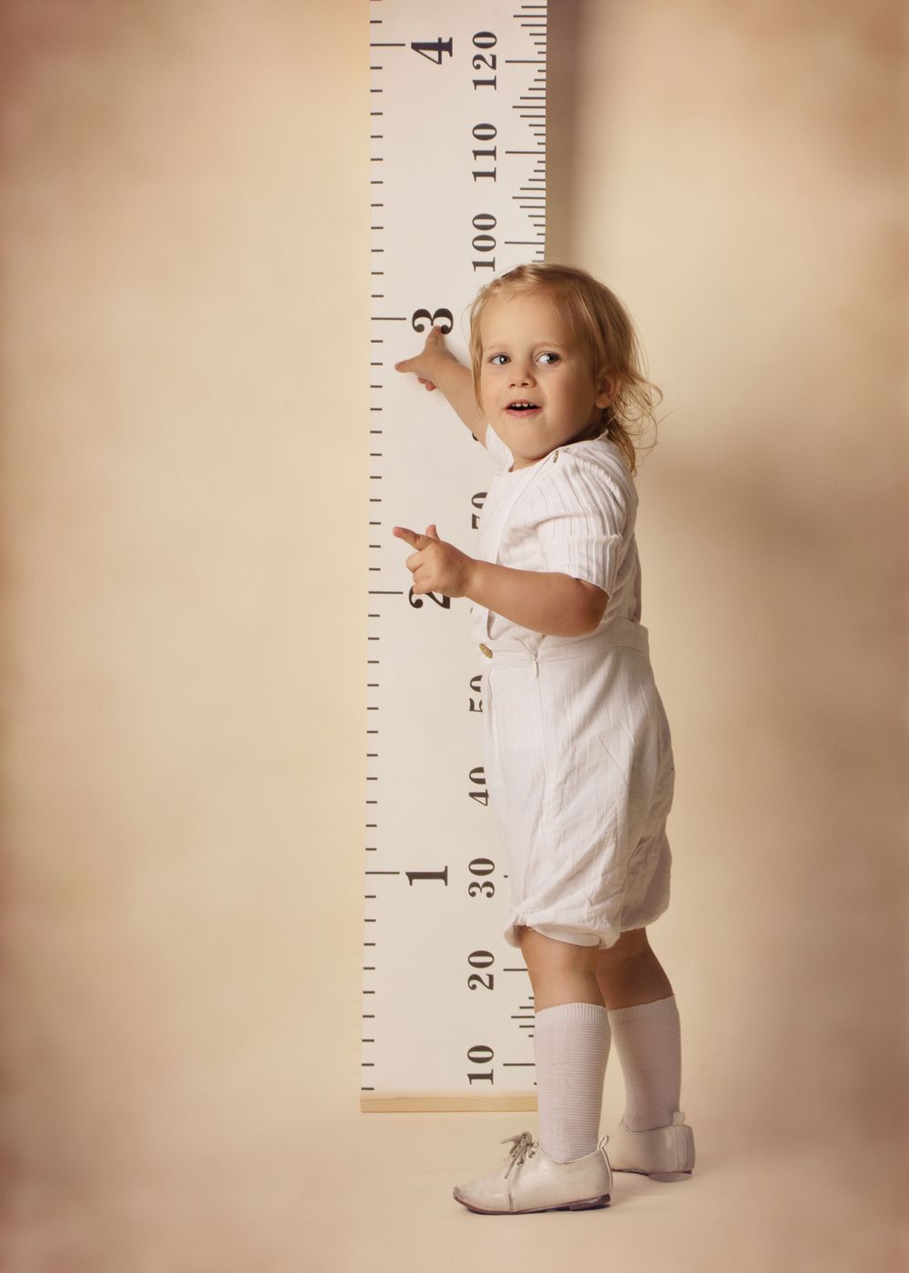 standing near a big tape measure showing he is 3