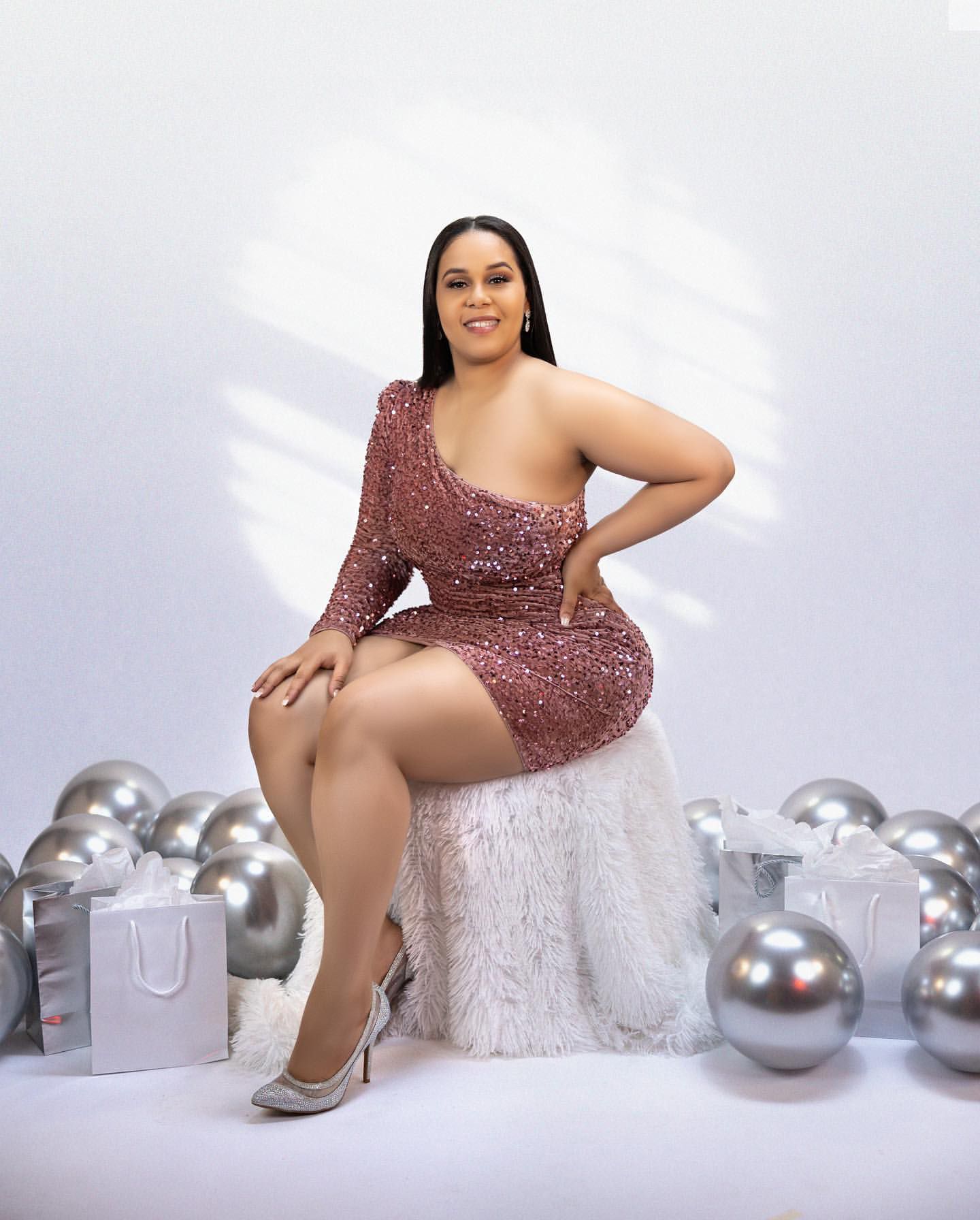 Glamorous birthday portrait in sparkly dress with silver decorations.