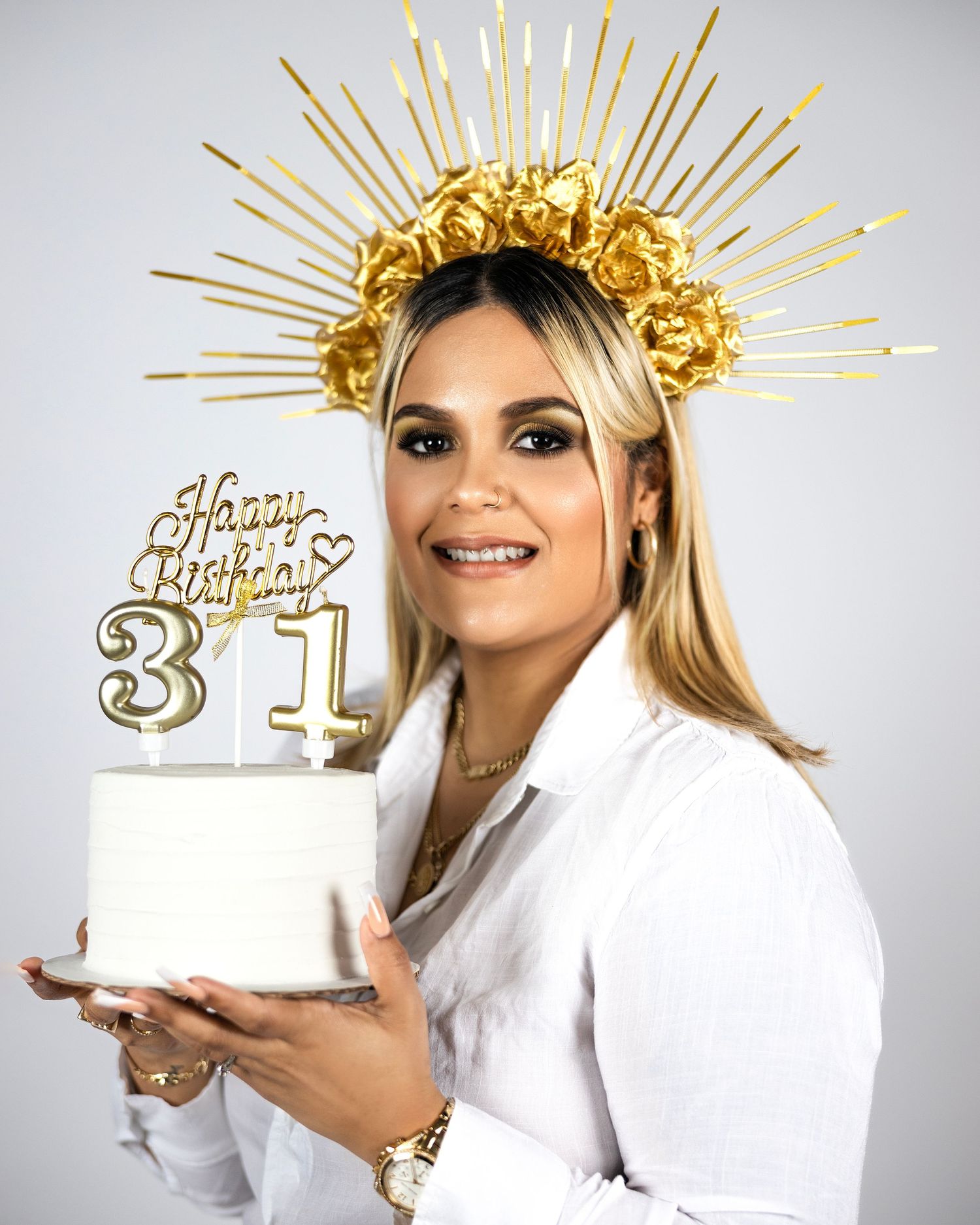 31st birthday portrait with gold crown headpiece and white cake.