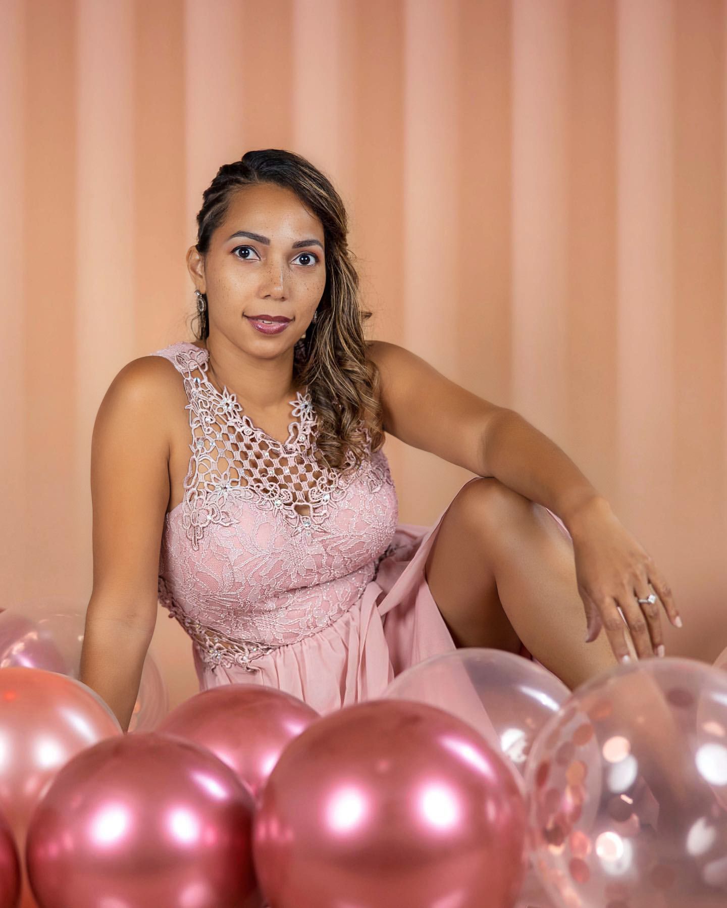 Elegant pink photoshoot with rose gold balloons and sparkly dress.