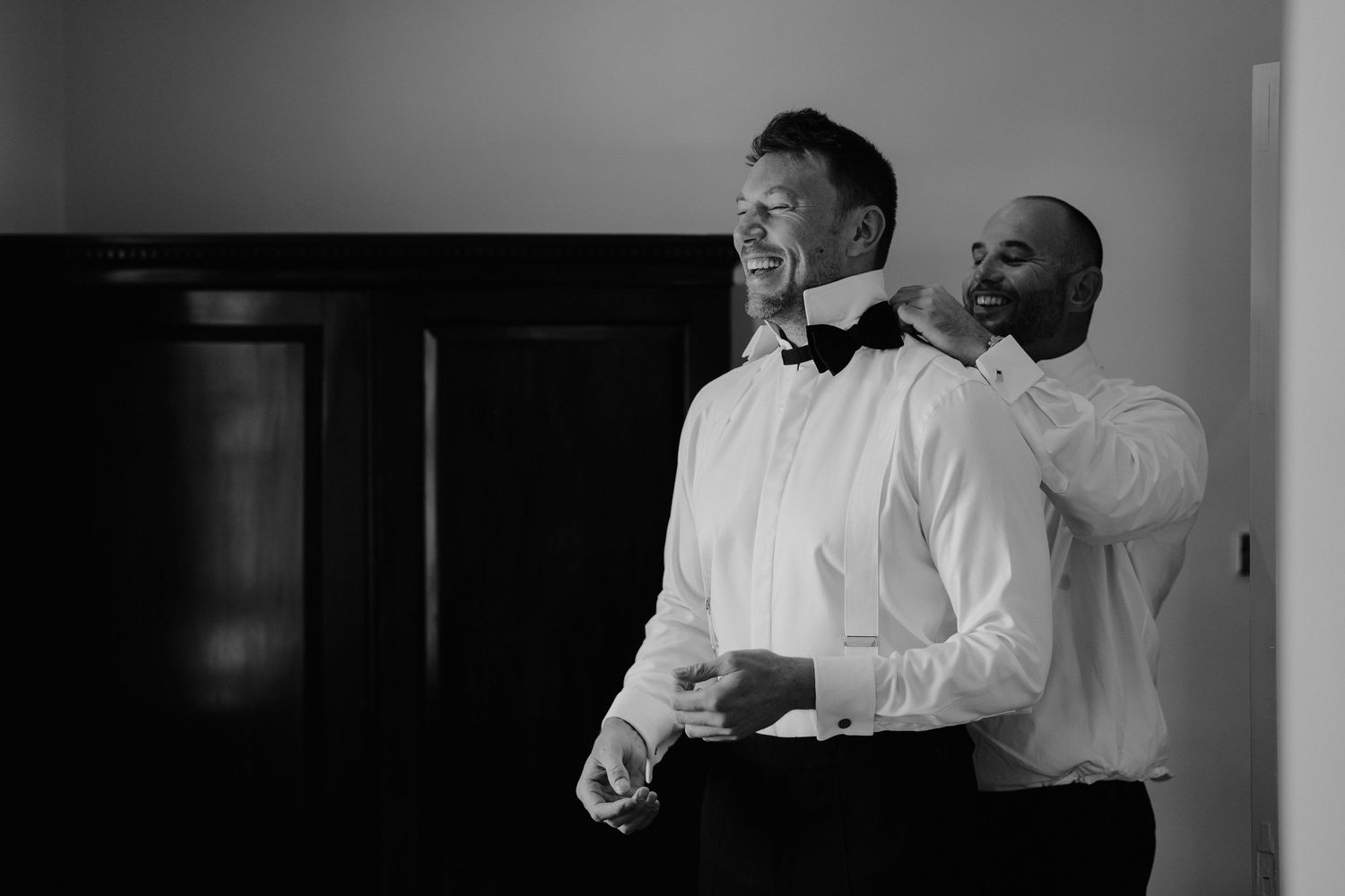 groom-and-bestman-tying-bowtie-stockton-house-wedding-shropshire