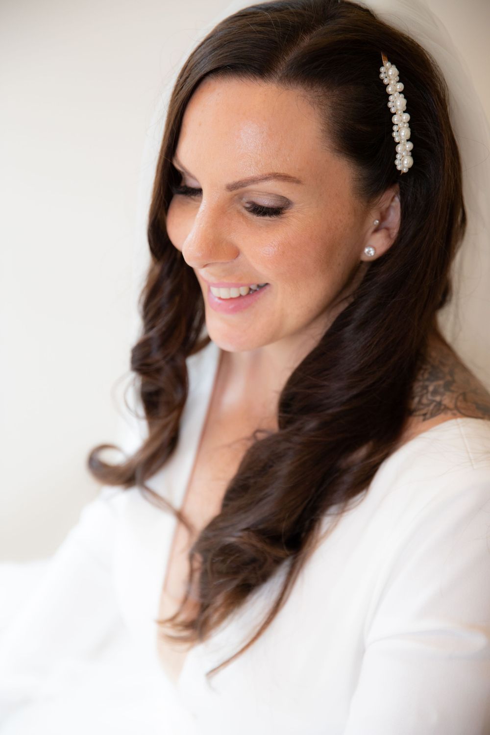Elegant bridal portrait with decorative hair accessory and soft makeup.