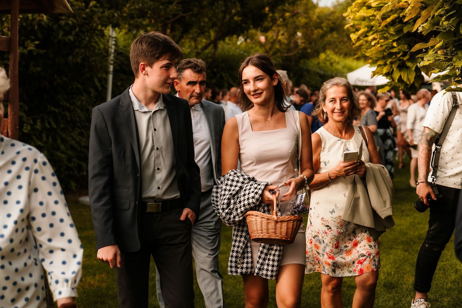 Guests enjoying a casual outdoor wedding reception on a sunny afternoon.