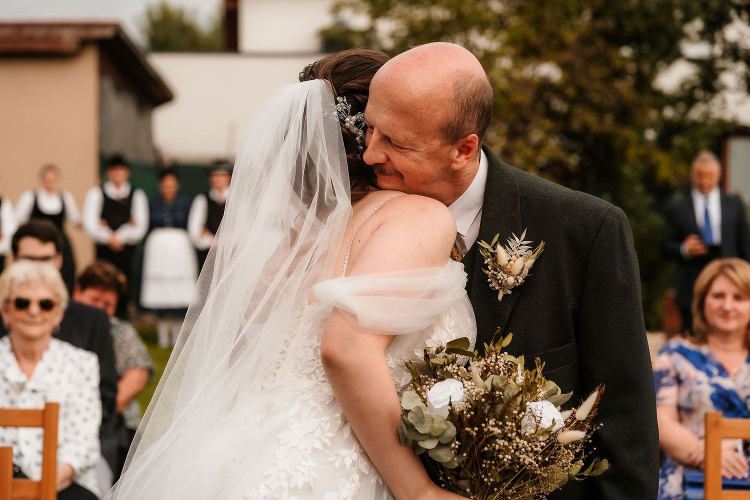 Emotional wedding moment captured during outdoor garden ceremony.