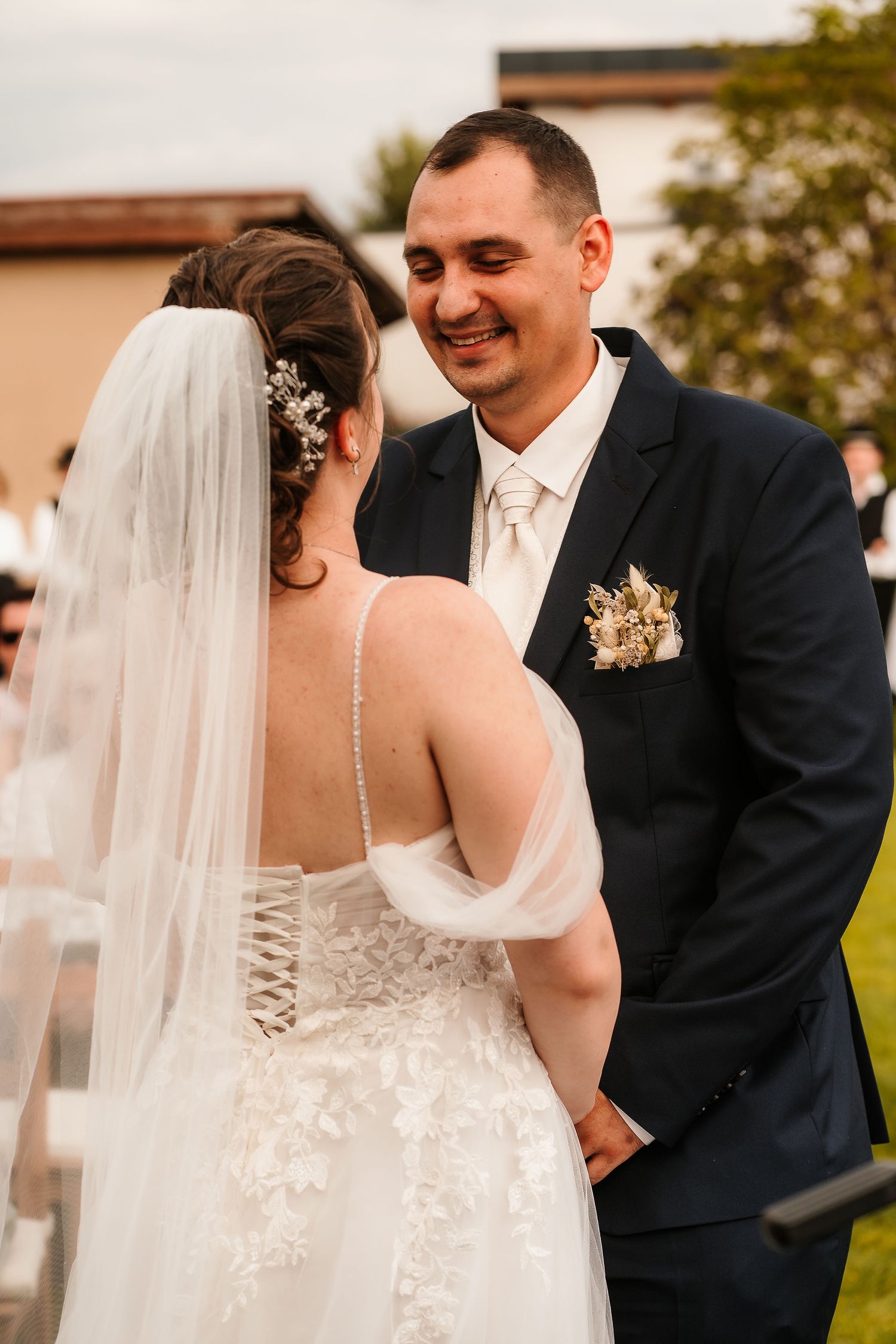 Intimate outdoor wedding portrait showing loving exchange between newlyweds.
