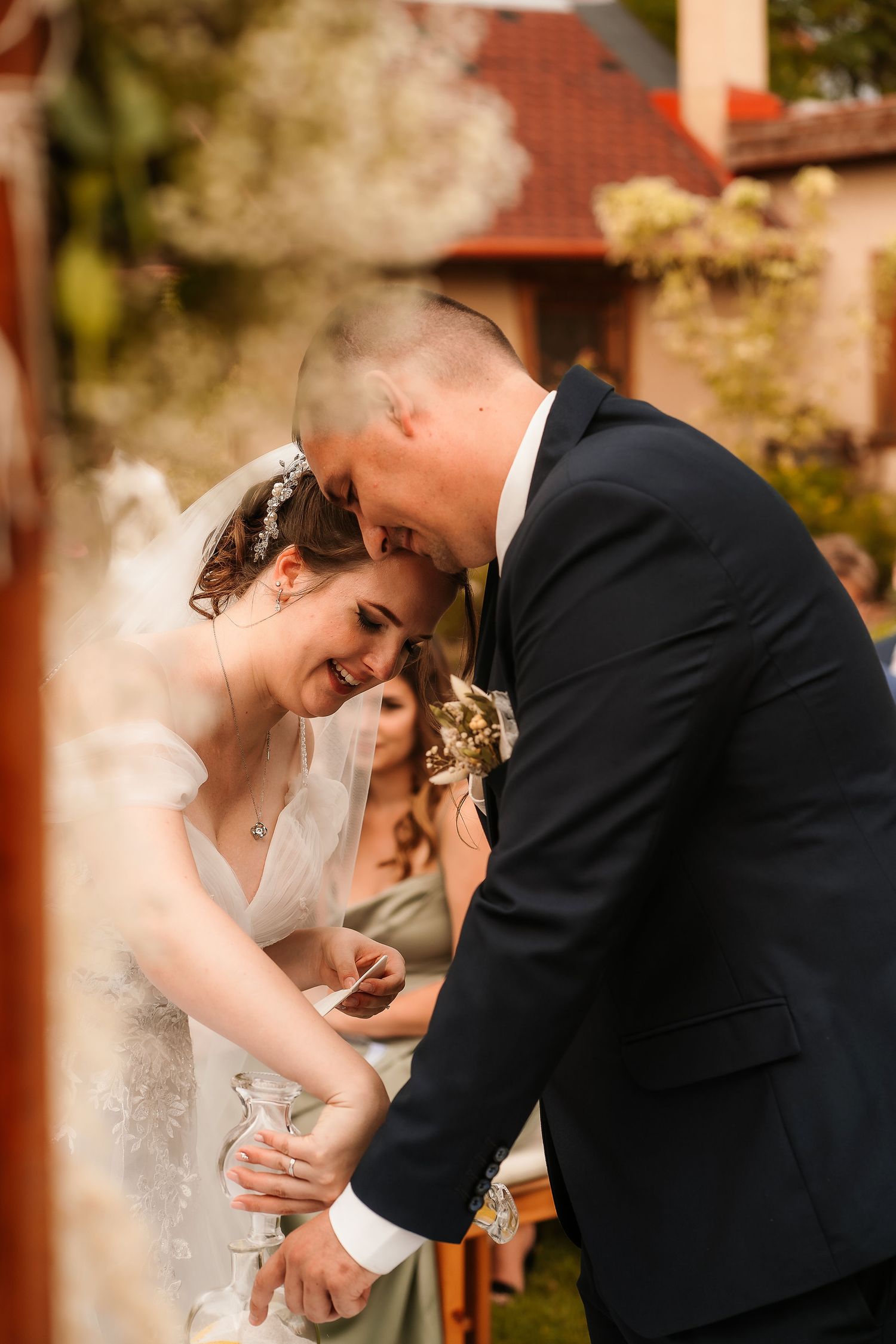 Candid moment of laughter shared between couple during their outdoor wedding ceremony.