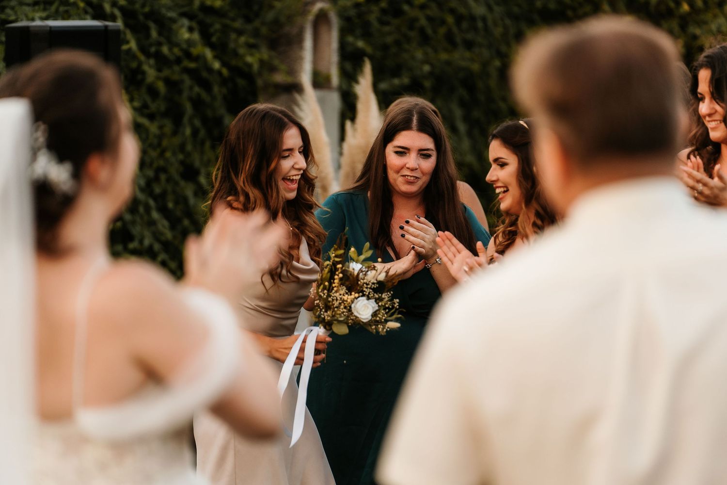 Wedding party gathering outdoors sharing an intimate moment during the celebration.