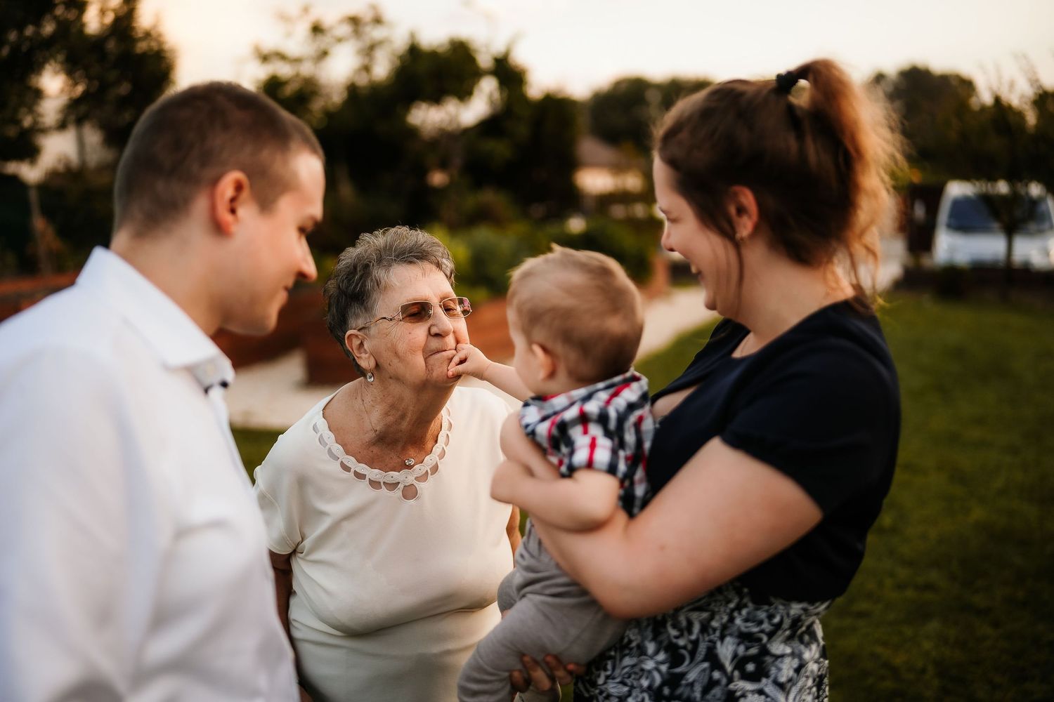 Family gathering outdoors during sunset celebration.