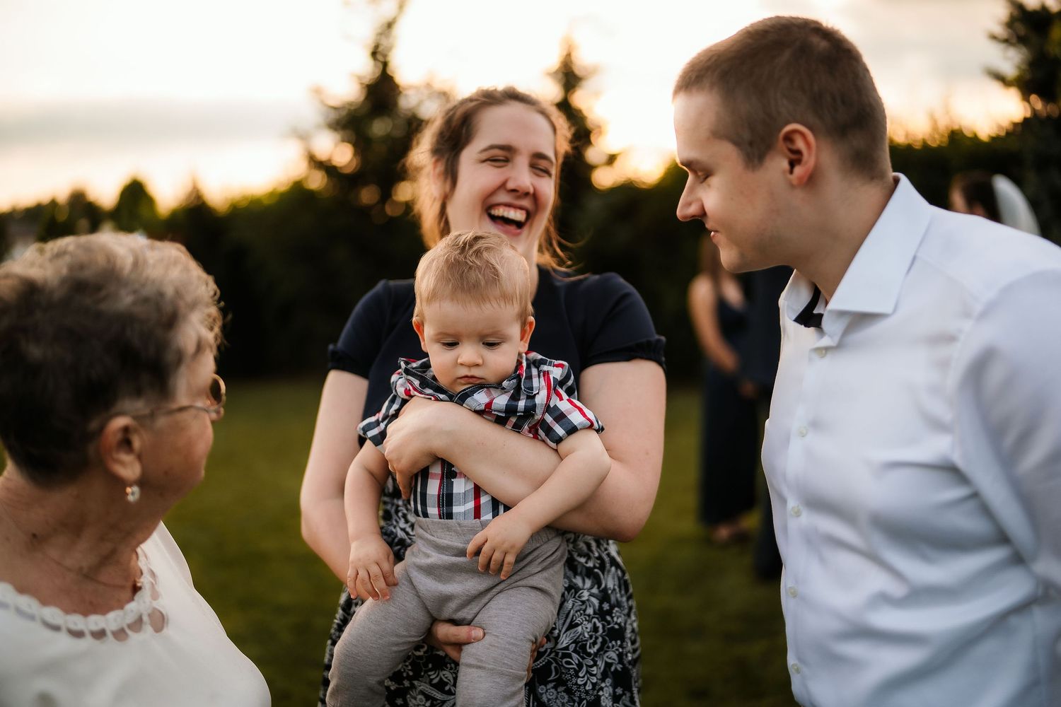 Joyful outdoor gathering with laughter and smiles at sunset.