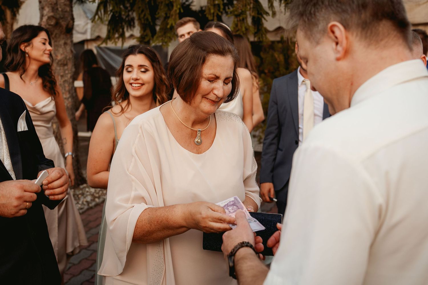 Wedding guests socializing during outdoor reception.