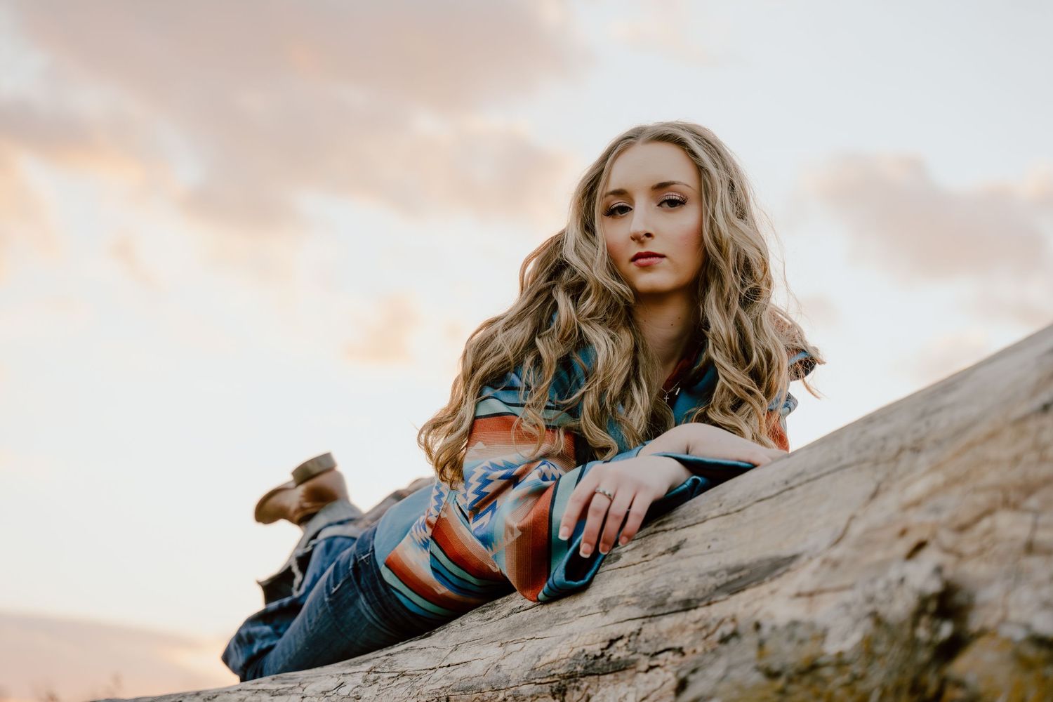 Artistic portrait series on rocky terrain during golden hour sunset.