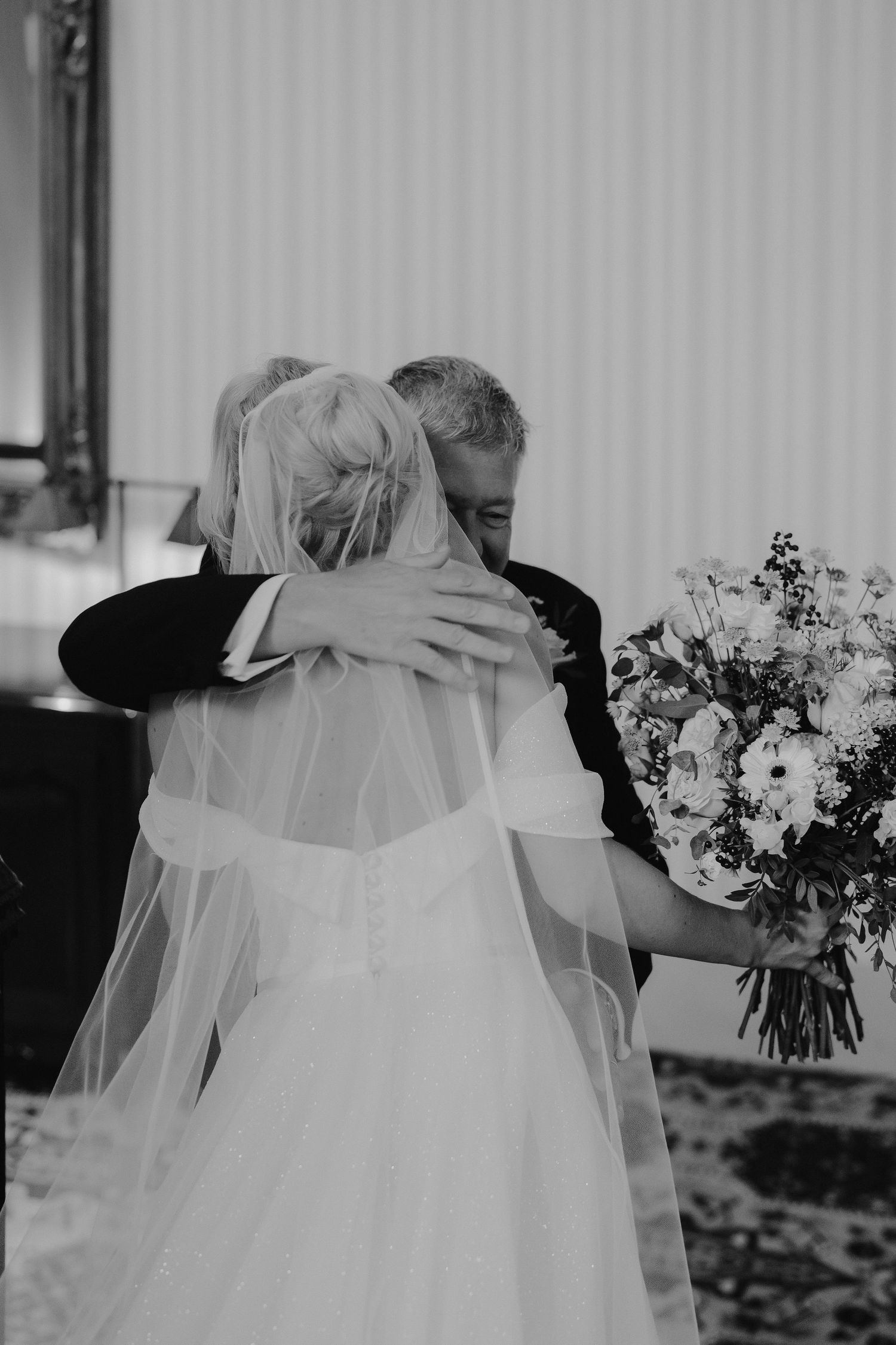 father of bride hugging bride after seeing her for the first time in her wedding dress at the Randolph hotel in Oxford