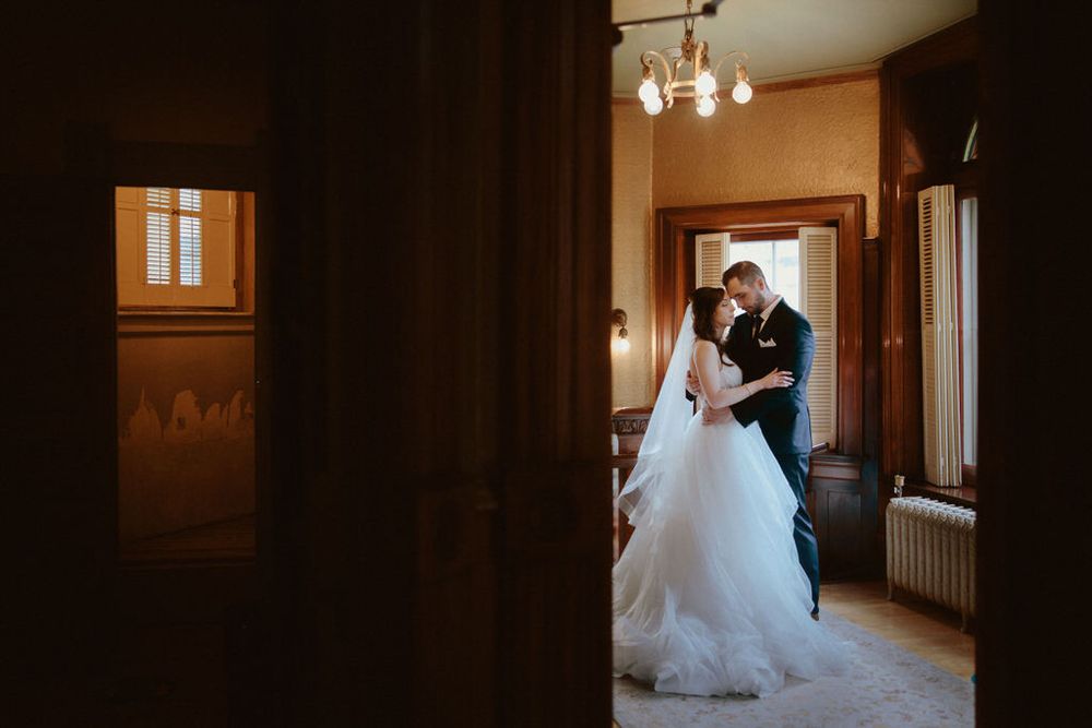 Bride and groom embracing on their wedding day with scenic backdrop | Calgary wedding photographer capturing romantic, timeless moments.