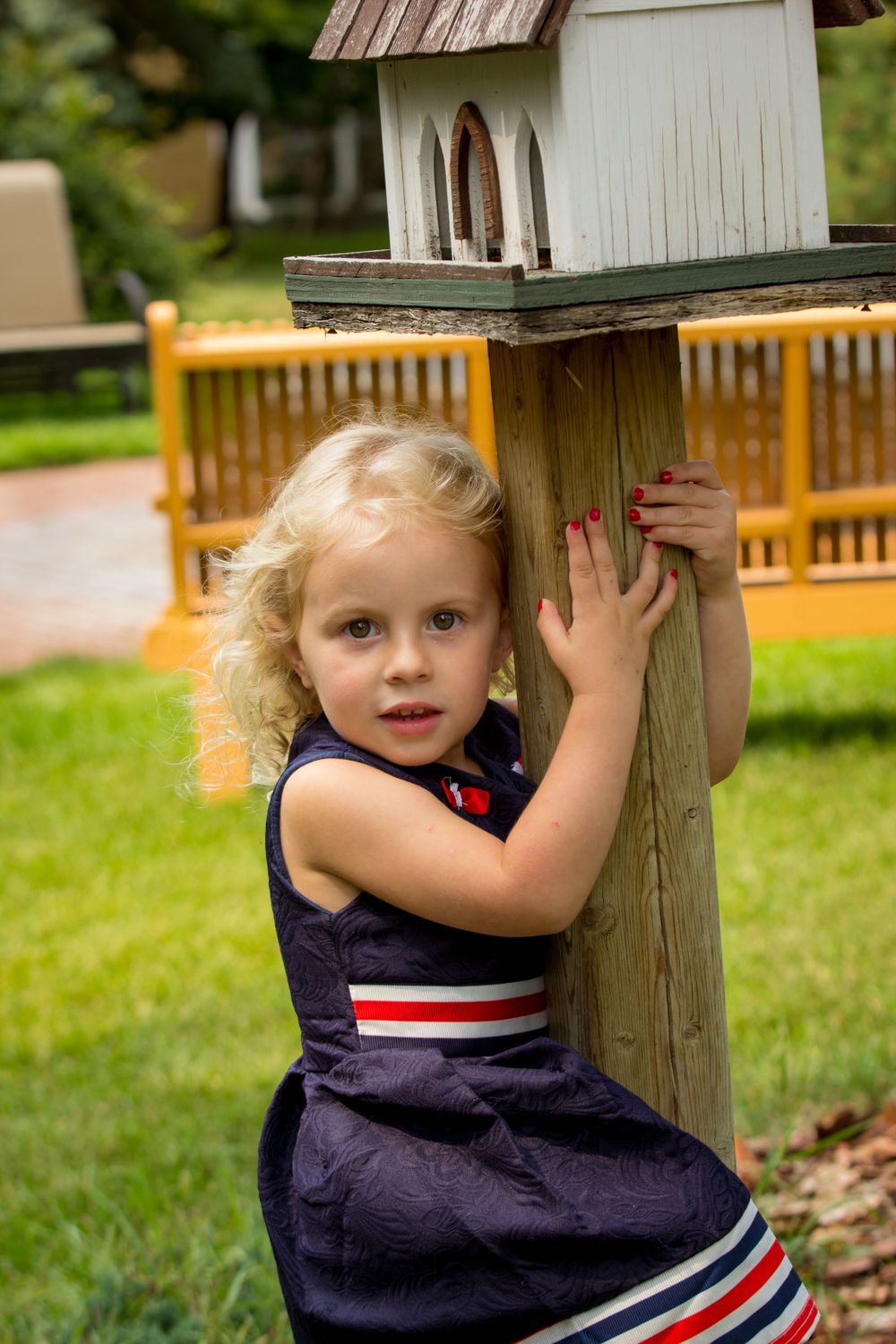 Girl playing near a treehouse and having her portrait taken