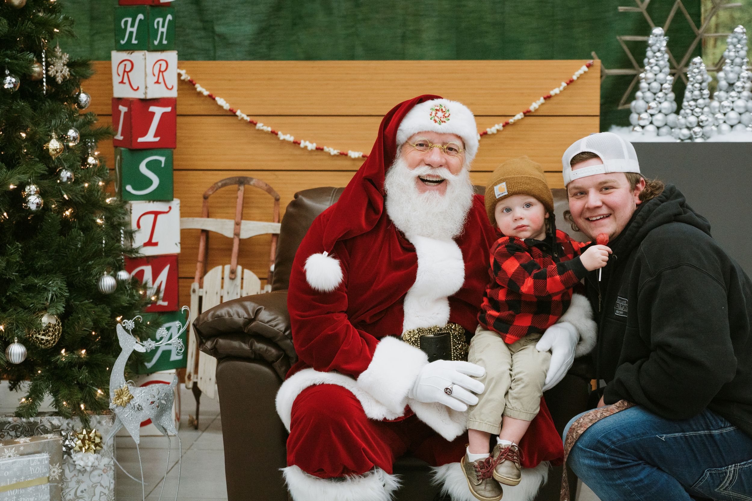 A heartwarming holiday portrait in front of a decorated Christmas tree.