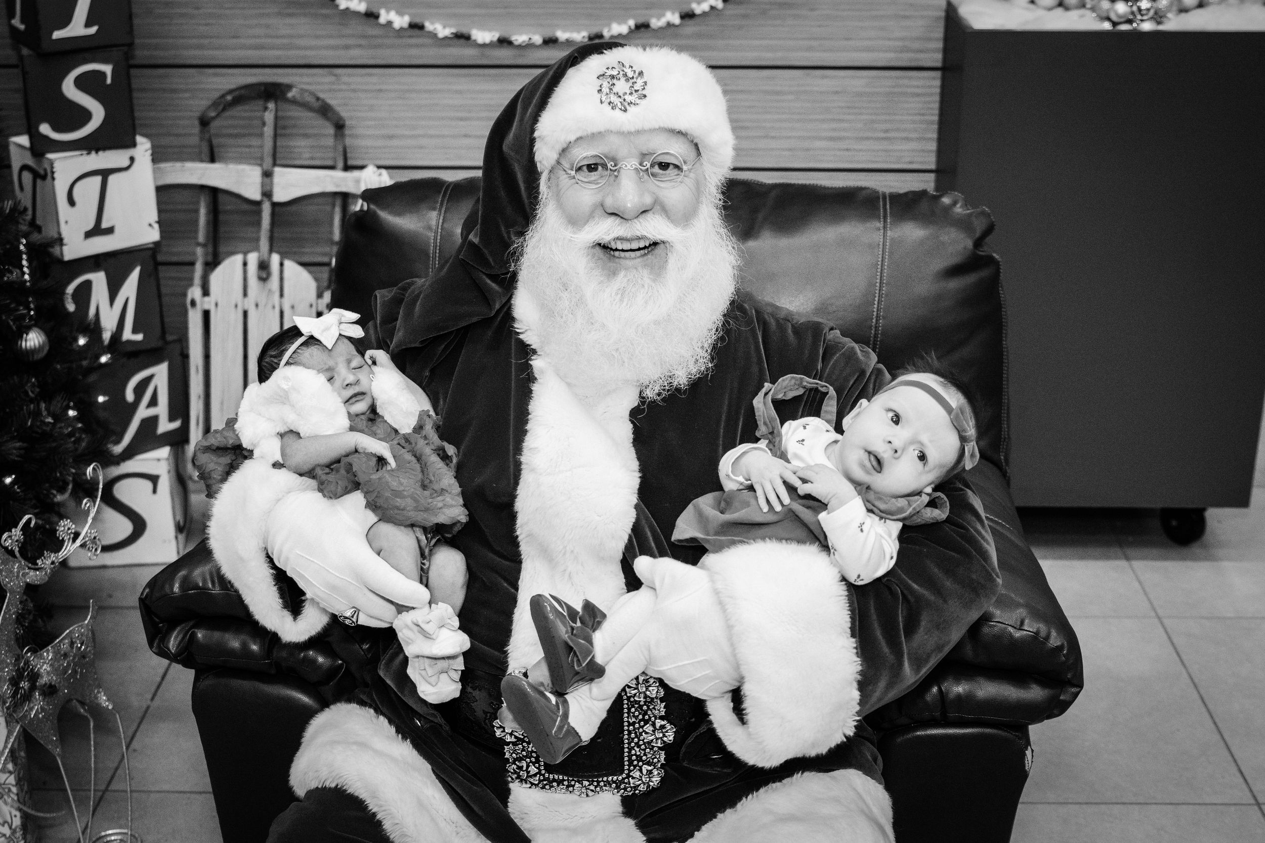 Black and white images capture heartwarming moments between children and Santa Claus during Christmas.