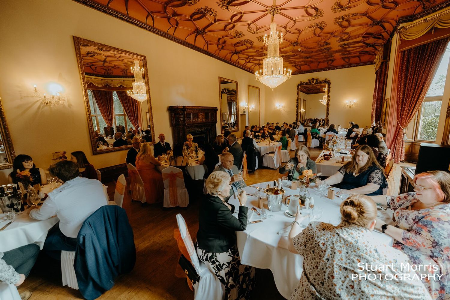 wedding guests take their seats for the wedding breakfast. ruthin castle wedding photographer Stuart Morris Photography