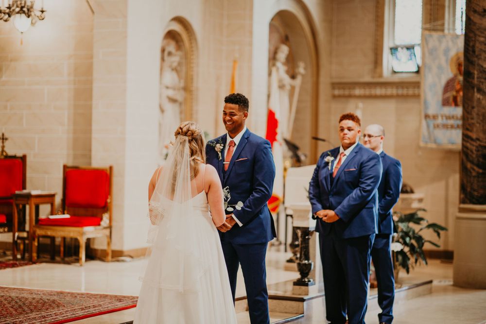 Bride and groom share a tender moment at the altar during a traditional church wedding ceremony.