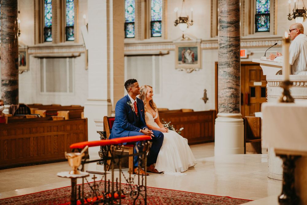 Bride and groom seated together at the altar during a church wedding ceremony.