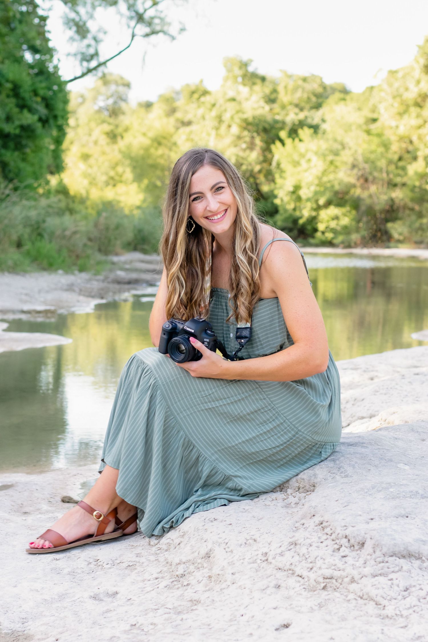 Smiling photographer in outdoor park with water in Austin, Texas