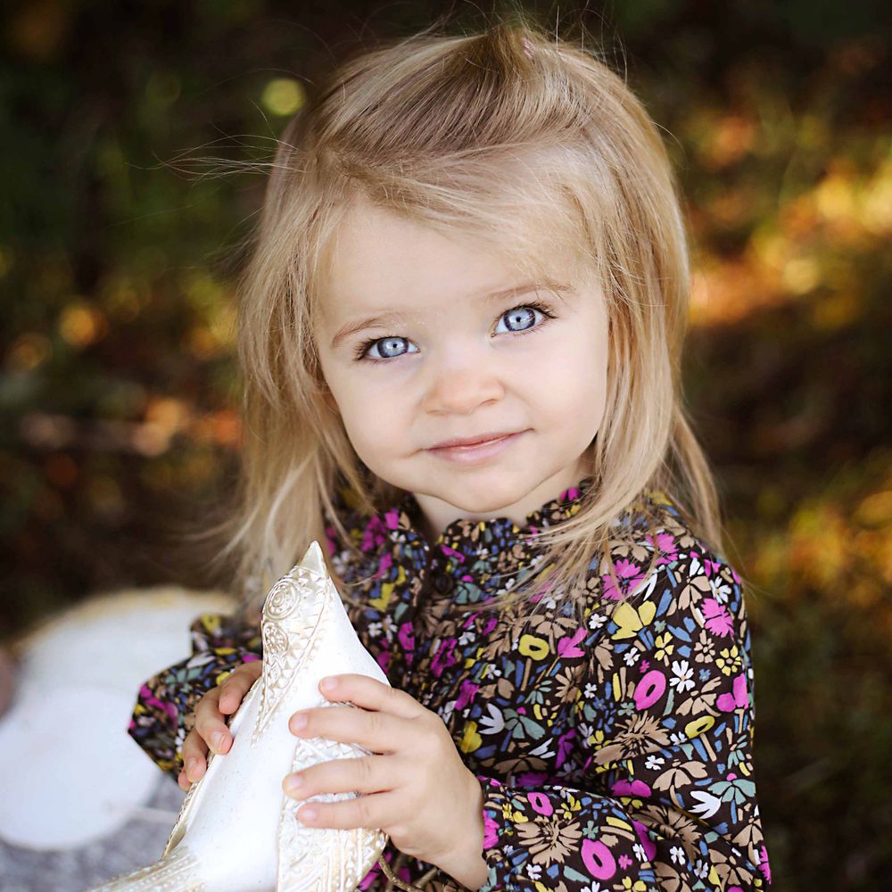 little girl holding a bird by victoria leigh photography