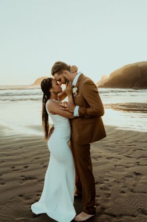 A romantic moment shared on a misty beach at sunset.