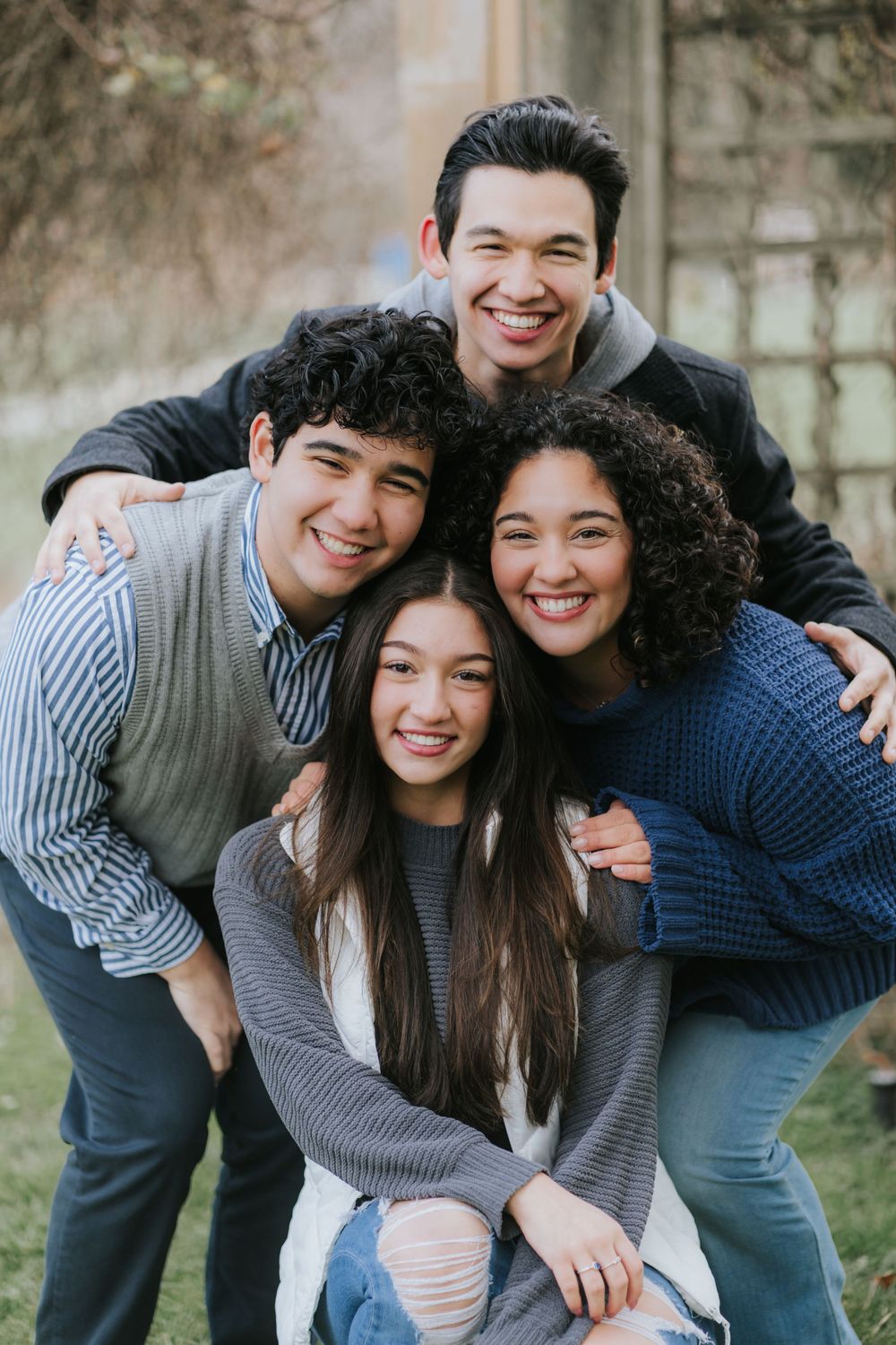 Group of friends huddled together outdoors sharing genuine laughter.