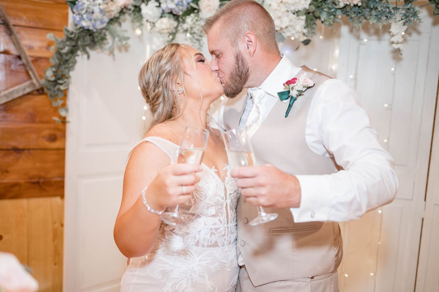 bride and groom kiss during toast