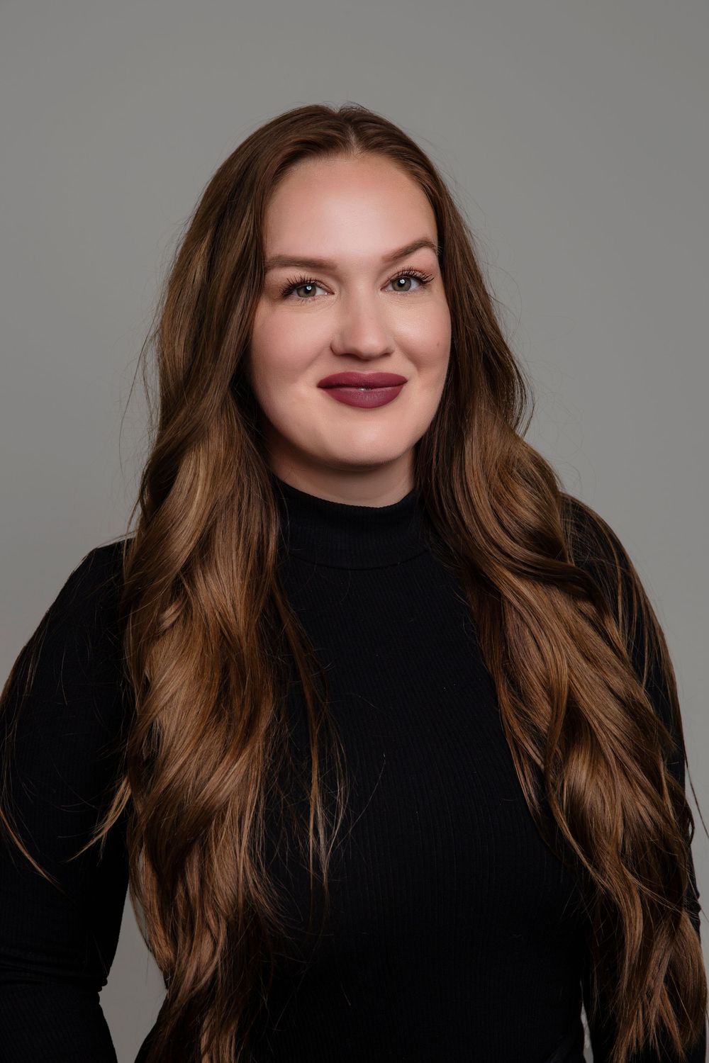 Studio portrait series featuring long brown hair and black turtleneck against neutral backdrop.