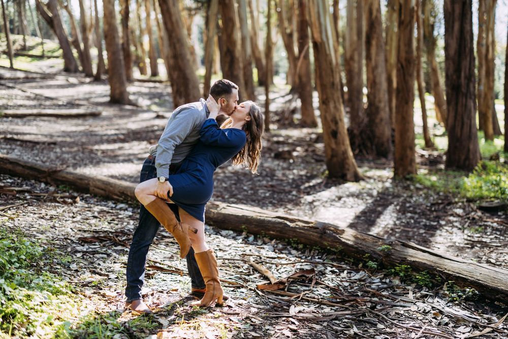 Lovers' Lane engagement portraits as the sun peeks through the trees.